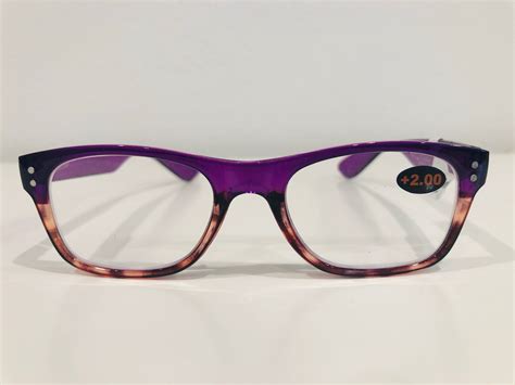 bono tinted purple reading glasses.